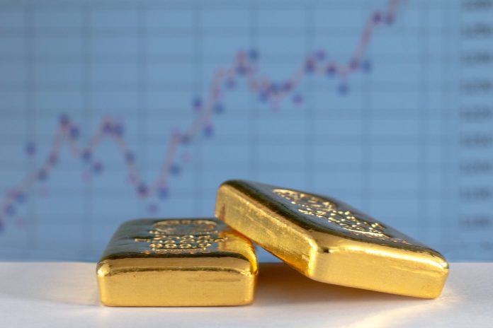 Gold bullions on the background of the growth chart.